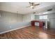 An open plan living room with wood floors and a built in wet bar at 3935 E Rough Rider Rd # 1164, Phoenix, AZ 85050