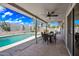 Inviting back patio with a pool and a covered outdoor dining area with a ceiling fan and string lights at 4136 W Hearn Rd, Phoenix, AZ 85053
