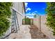 Backyard with small metal shed and rocks, and a large green bush at 4136 W Hearn Rd, Phoenix, AZ 85053