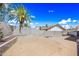 Backyard with large cinderblock fence, palm tree and dirt at 4136 W Hearn Rd, Phoenix, AZ 85053