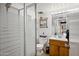 A bathroom with a modern shower, wooden vanity, toilet, and stylish decor at 4136 W Hearn Rd, Phoenix, AZ 85053