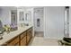 Bathroom with a dual sink vanity, tile floor, decorative towels, and a mirror at 4136 W Hearn Rd, Phoenix, AZ 85053