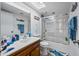 A well-lit bathroom with a vanity, toilet, and glass-enclosed shower-tub at 4136 W Hearn Rd, Phoenix, AZ 85053