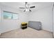 A bedroom with white walls, carpet, ceiling fan, window, and a mattress at 4136 W Hearn Rd, Phoenix, AZ 85053