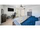 Bedroom with a ceiling fan, large bed, dark-wood dresser, and white desk at 4136 W Hearn Rd, Phoenix, AZ 85053