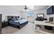 Bedroom with a ceiling fan, large bed and desk with a black office chair at 4136 W Hearn Rd, Phoenix, AZ 85053