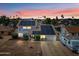 Charming two-story home with solar panels and well-maintained landscaping at sunset at 4136 W Hearn Rd, Phoenix, AZ 85053