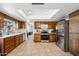 Well-lit kitchen with stainless steel appliances, tiled flooring, and skylight at 4136 W Hearn Rd, Phoenix, AZ 85053