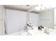 Bright bathroom featuring shower over tub, shower curtain, sink, and mirror at 4201 E Camelback Rd # 51, Phoenix, AZ 85018