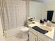 Bright bathroom featuring a tub and shower, neutral decor, and a vanity at 4201 E Camelback Rd # 51, Phoenix, AZ 85018
