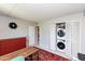 Bedroom featuring washer/dryer, red dresser, a desk, and rug at 4201 E Camelback Rd # 51, Phoenix, AZ 85018