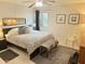Bright bedroom with a ceiling fan, neutral decor, and a window view of foliage at 4201 E Camelback Rd # 51, Phoenix, AZ 85018