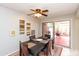 Dining room featuring dark wood table, ceiling fan, and sliding door access to outdoor patio at 4201 E Camelback Rd # 51, Phoenix, AZ 85018