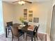 Dining area featuring a dark wood table with seating for four on a patterned rug at 4201 E Camelback Rd # 51, Phoenix, AZ 85018