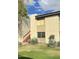 Exterior facade of property with a green lawn, mature yucca and outdoor staircase at 4201 E Camelback Rd # 51, Phoenix, AZ 85018