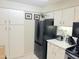 Bright kitchen with white cabinets, black appliances, and clean countertops at 4201 E Camelback Rd # 51, Phoenix, AZ 85018