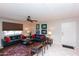 Bright living room features neutral walls, tile floor, black sofas with red pillows, and ceiling fan at 4201 E Camelback Rd # 51, Phoenix, AZ 85018