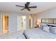 Relaxing main bedroom featuring neutral walls, ceiling fan, tiled flooring, and access to bathroom and walk-in closet at 4201 E Camelback Rd # 51, Phoenix, AZ 85018