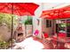 Charming patio area featuring red umbrellas, bistro seating, and a brick barbecue at 4201 E Camelback Rd # 51, Phoenix, AZ 85018