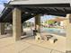 Community pool and lounging area with covered patio seating, tables, and beautiful landscaping at 4201 E Camelback Rd # 51, Phoenix, AZ 85018