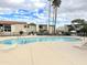 Resort-style community pool area with lounge chairs, palm trees, and well-maintained landscaping on a partly cloudy day at 4201 E Camelback Rd # 51, Phoenix, AZ 85018