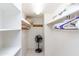 Walk-in closet with bright light, white shelving, and tile floor at 4201 E Camelback Rd # 51, Phoenix, AZ 85018