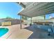 Backyard with covered patio, full outdoor kitchen, and built-in seating surrounding a fire pit at 4201 W Hatcher Rd, Phoenix, AZ 85051