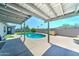 Beautiful backyard featuring a covered patio, a refreshing pool, and a well-maintained concrete deck at 4201 W Hatcher Rd, Phoenix, AZ 85051