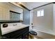 Renovated bathroom with black vanity, tub/shower combo, and large framed mirror at 4201 W Hatcher Rd, Phoenix, AZ 85051