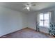 This simple bedroom features a window for natural light, carpet, and a ceiling fan at 4201 W Hatcher Rd, Phoenix, AZ 85051