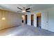 Spacious bedroom features neutral colors, ceiling fan, closets, and an en suite bathroom at 4201 W Hatcher Rd, Phoenix, AZ 85051
