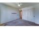 A basic bedroom featuring carpet, a ceiling fan, and a closet at 4201 W Hatcher Rd, Phoenix, AZ 85051