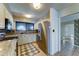 Well-lit kitchen featuring stainless steel refrigerator and decorative tile flooring at 4201 W Hatcher Rd, Phoenix, AZ 85051