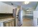 Stainless steel refrigerator complements the granite countertops and tiled backsplash at 4201 W Hatcher Rd, Phoenix, AZ 85051