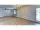 Large living room featuring tile floors, a ceiling fan, and views of the outdoor pool area at 4201 W Hatcher Rd, Phoenix, AZ 85051