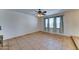 Bright living room with large windows, tiled flooring, and a modern ceiling fan at 4201 W Hatcher Rd, Phoenix, AZ 85051