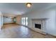 Spacious living room featuring tile flooring, a fireplace, and access to the outdoor area at 4201 W Hatcher Rd, Phoenix, AZ 85051