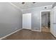 This bedroom features a ceiling fan, wood-look floors, and a double-door closet at 4304 W Calle Poco --, Laveen, AZ 85339