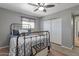 Comfortable bedroom with a metal-frame bed, sliding closet doors, and neutral decor at 4304 W Calle Poco --, Laveen, AZ 85339