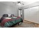 Bedroom featuring wood flooring, a bed with colorful bedding, and sliding closet doors at 4304 W Calle Poco --, Laveen, AZ 85339