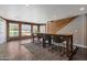 Sunlit dining area with long table, seating for eight, brick walls, and views of the outdoor pool at 4304 W Calle Poco --, Laveen, AZ 85339