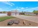 Charming single-story home with a brick facade, a spacious driveway, and a well-maintained lawn and stone decor at 4304 W Calle Poco --, Laveen, AZ 85339