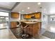 Bright kitchen featuring wooden cabinets, tiled backsplash, island with seating, and modern appliances at 4304 W Calle Poco --, Laveen, AZ 85339