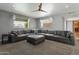 Spacious living room featuring plush carpeting, neutral paint, large windows, and a comfortable oversized sectional couch at 4304 W Calle Poco --, Laveen, AZ 85339