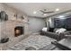 Cozy living room with a brick fireplace, shelving, comfortable seating, and modern decor at 4304 W Calle Poco --, Laveen, AZ 85339