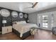 Stylish main bedroom boasts a decorative wall, ceiling fan and access to the backyard at 4304 W Calle Poco --, Laveen, AZ 85339