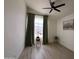 Minimalist bedroom with wood-look floors and a large window dressed with decorative curtains at 4925 W Bluefield Ave, Glendale, AZ 85308