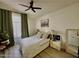 Comfortable bedroom with neutral tones, a ceiling fan, and window with green curtains at 4925 W Bluefield Ave, Glendale, AZ 85308