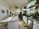 Stylish kitchen with large island, stainless steel appliances, and bright white cabinets at 4925 W Bluefield Ave, Glendale, AZ 85308