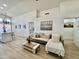 Bright living room with modern wood floors, white walls, couch, and coffee table at 4925 W Bluefield Ave, Glendale, AZ 85308